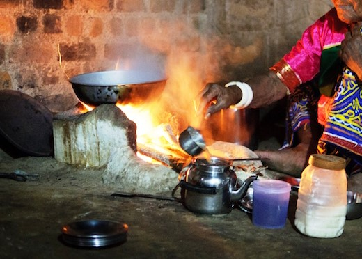 Photo: A woman prepares a meal over a three-stone fire in India - Global Alliance for Clean Cookstoves.