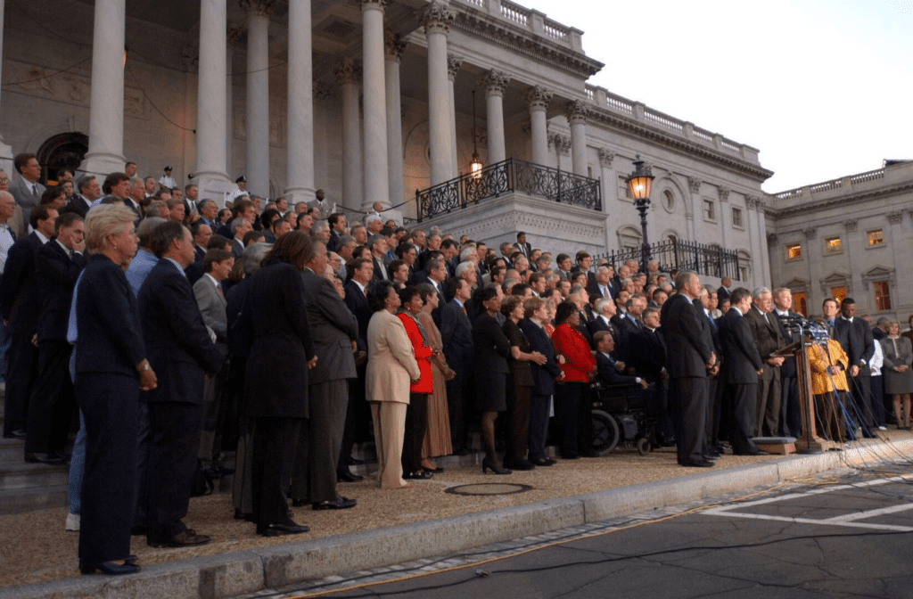 A photograph of a bipartisan and bicameral delegation of Congress on the Capitol steps on 9/11.