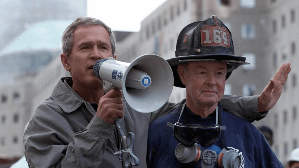 President Bush with retired Firefighter Bob Beckwith before issuing the phrase: "I can hear you! The rest of the world hears you," replied Bush. "And the people who knocked these buildings down will hear all of us soon."